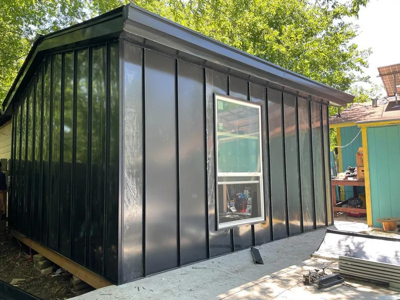 Black standing seam metal wall panels for Roof Inspection in Youngsville